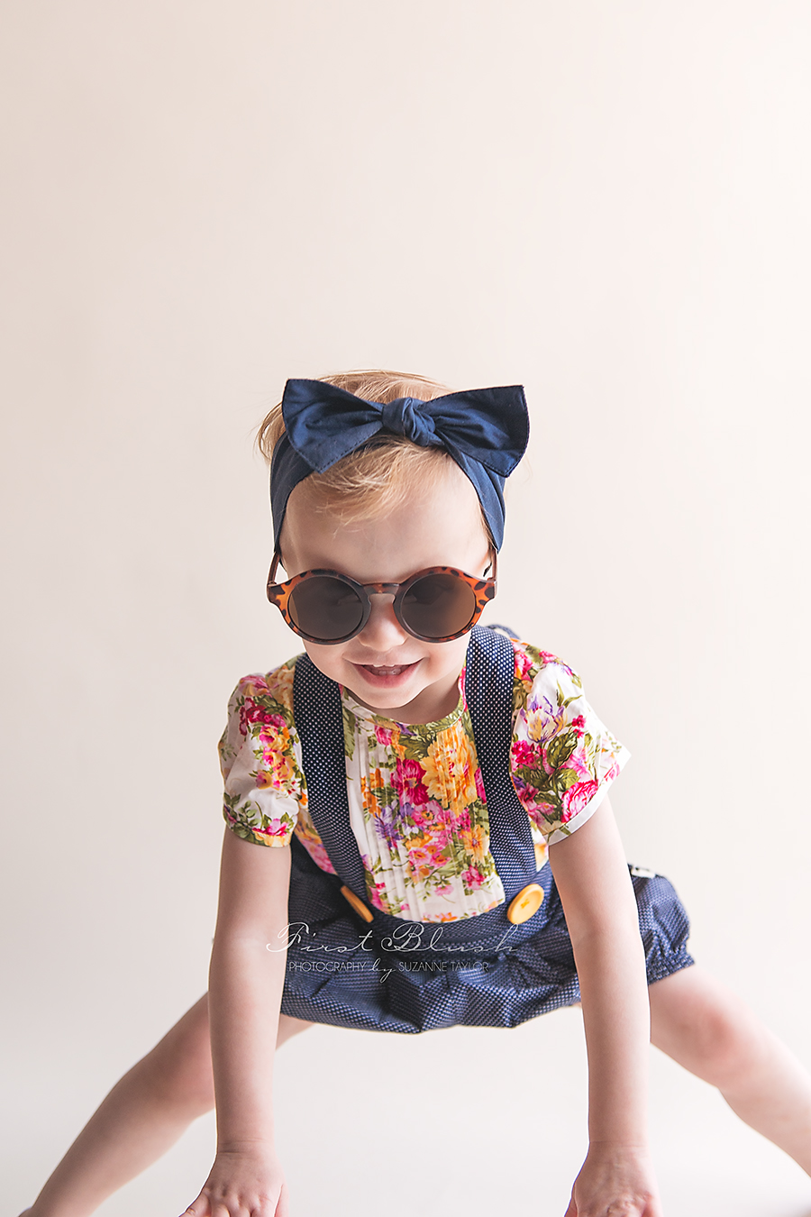 Girl wearing Lacey Lane sunglasses smiling at the camera.