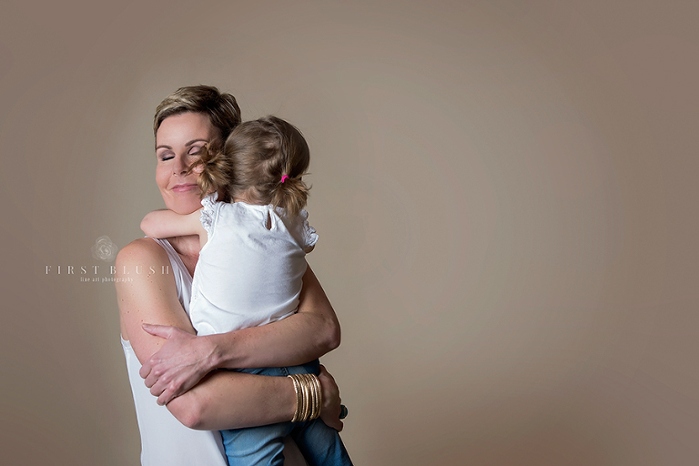 A mother holding her daughter in her arms