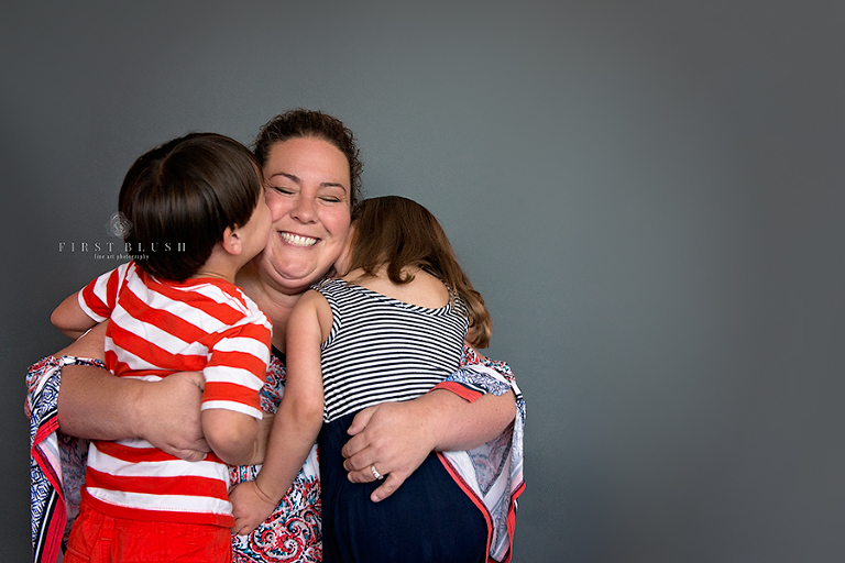 What happened - a mom hugging her twin children from a mini session with Suzanne Taylor Photography from 2015.