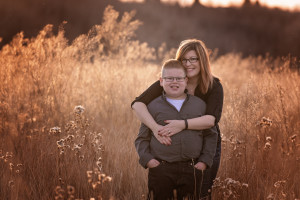 A mom and her son hugging during fall photos in Calgary Alberta