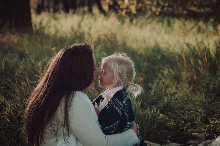 Red Deer Photographer Suzanne Taylor rubs noses with her smallest daughter and triplet. Image taken by Reina Procee out of Montreal.