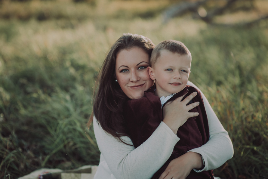 Red Deer Photographer Suzanne Taylor sits with her oldest son during a family photography session.