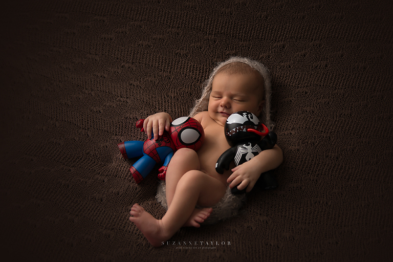 Calgary newborn Archer hugs his Spiderman toys